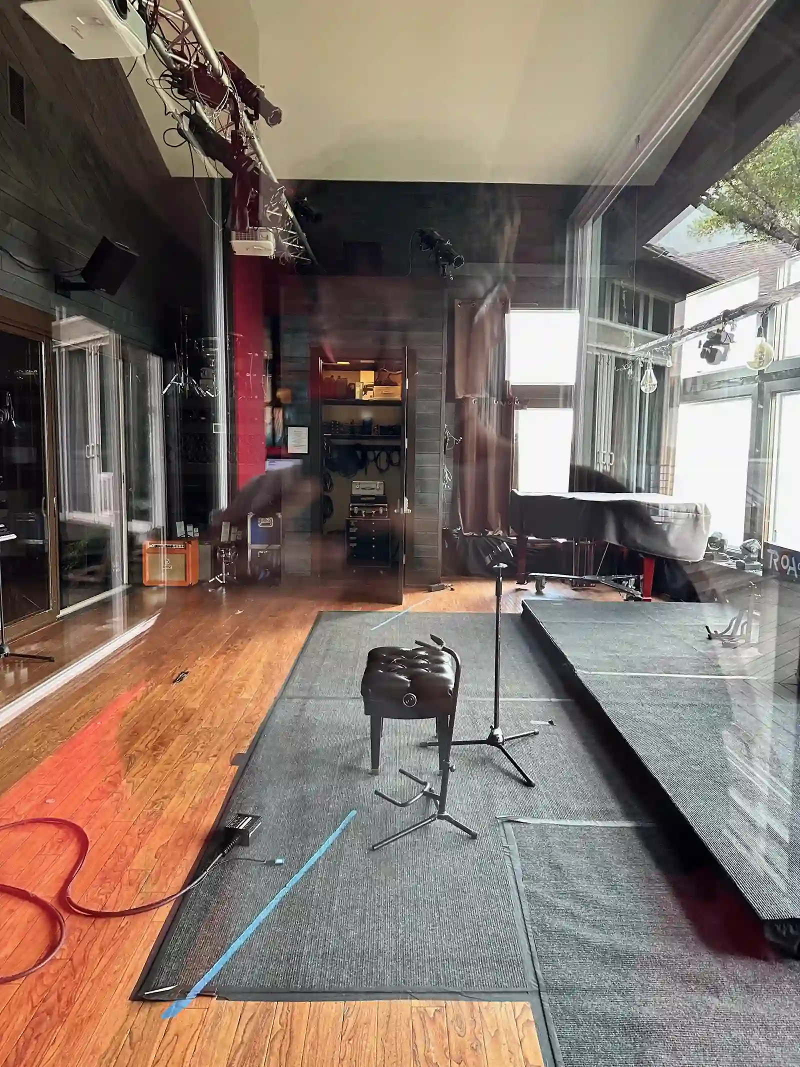 The live room at TRCoA — wood floors, grand piano, sound-treated walls